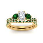 Load image into Gallery viewer, radiant-cut-twisted-floral-prong-emerald-wedding-set-in-yellow-gold-FD10257RAGEMGR-ANGLE5-NL-YG_769bf6d2-fa85-42d0-8577-ded4132b34a2?v=1756360178
