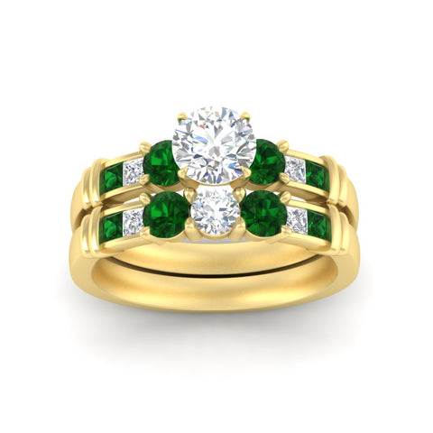 round-cut-bridal-ring-set-with-emerald-princess-channel-accents-in-yellow-gold-fdens286rogemgrangle5-nl-yg.jpg