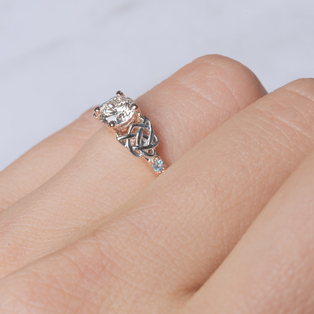 round-cut-celtic-diamond-ring-with-blue-topaz-in-rose-gold-FDENS2255RORGICBLTOANGLE1-NL-RG