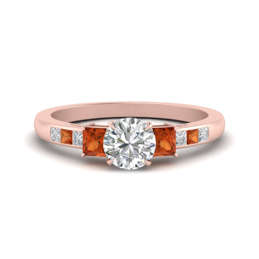 round-cut-channel-three-stone-diamond-engagement-ring-with-orange-sapphire-in-rose-gold-FDENS205RORGSAOR-NL-RG.jpg