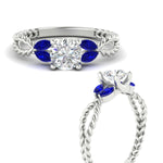 Load image into Gallery viewer, round-cut-twisted-leaf-sapphire-split-engagement-ring-in-white-gold-fdenr1084gsablangle3-nl-wg_3cd93c49-0db0-44fe-b33e-f87db163aa9b.jpg?v=1764581107
