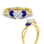 Load image into Gallery viewer, round-cut-twisted-leaf-sapphire-split-engagement-ring-in-yellow-gold-fdenr1084gsablangle3-nl-yg.jpg?v=1764581094
