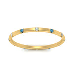 Load image into Gallery viewer, thin-space-out-stackable-diamond-band-with-blue-topaz-in-yellow-gold-FDEWB9437RORGICBLTOANGLE5-NL-YG
