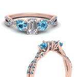 Load image into Gallery viewer, trellis-twisted-3-stone-emerald-cut-diamond-ring-blue-topaz-in-rose-gold-FD123699EMRGICBLTOANGLE3-NL-RG_850aac86-5ee7-40fe-ad69-407d2c814b24?v=1756181838
