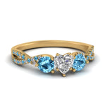 Load image into Gallery viewer, trellis-twisted-3-stone-heart-shaped-diamond-ring-blue-topaz-in-yellow-gold-FD123699HTRGICBLTO-NL-YG_fa728fae-abff-474c-8866-f02023727358?v=1756181852
