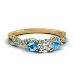 Load image into Gallery viewer, trellis-twisted-3-stone-round-cut-diamond-ring-blue-topaz-in-yellow-gold-FD123699RORGICBLTO-NL-YG_0e45ea6a-b394-476b-b104-38b66982fa22?v=1756181932
