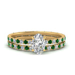 Load image into Gallery viewer, underhalo-eternity-oval-shaped-diamond-wedding-band-set-with-emerald-in-FD9168OVGEMGRANGLE3-NL-YG
