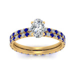 Load image into Gallery viewer, underhalo-eternity-oval-shaped-diamond-wedding-band-set-with-sapphire-in-FD9168OVGSABLANGLE3-NL-YG
